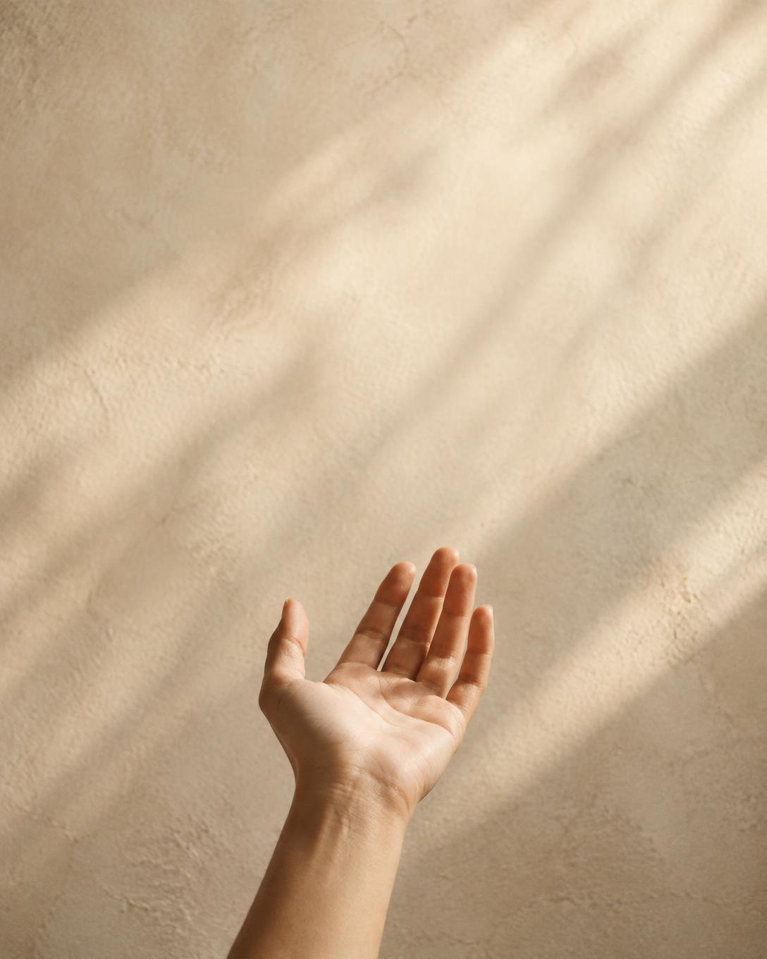 Hand raised in a quiet moment of prayer